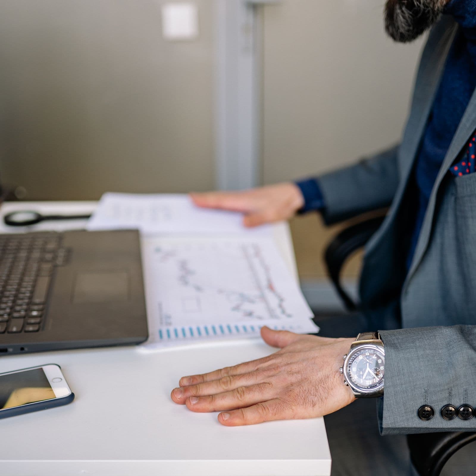 Figures being passed across a desk during a review