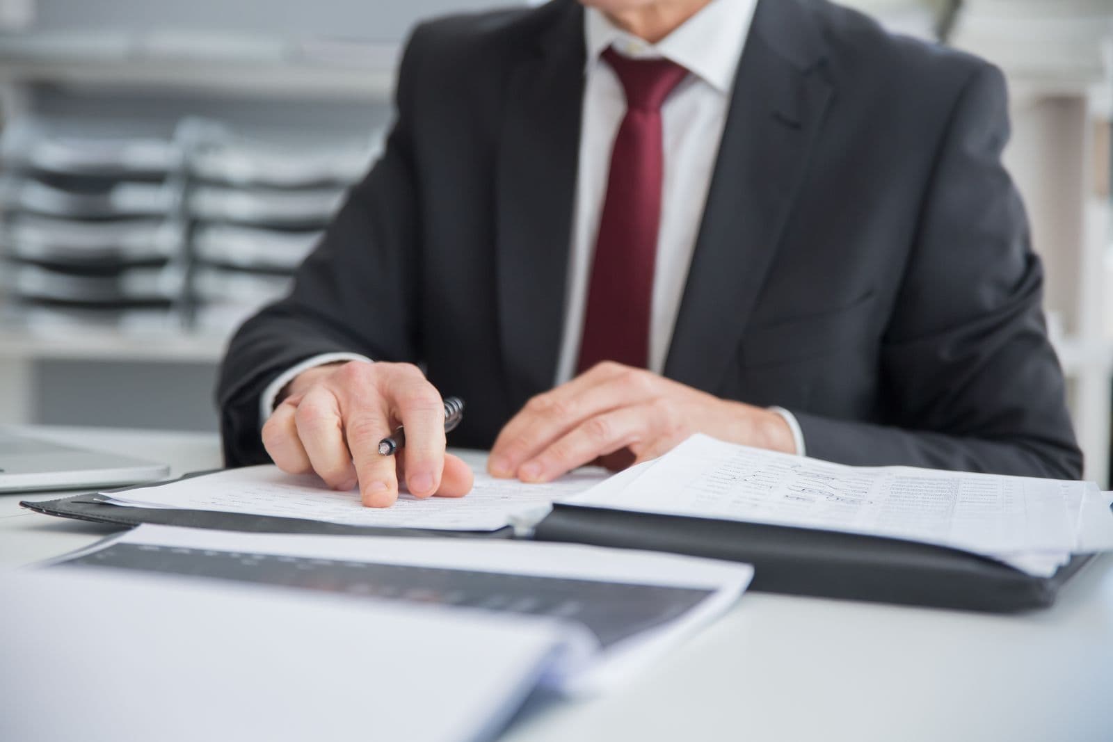 A funding officer working through a file at his desk